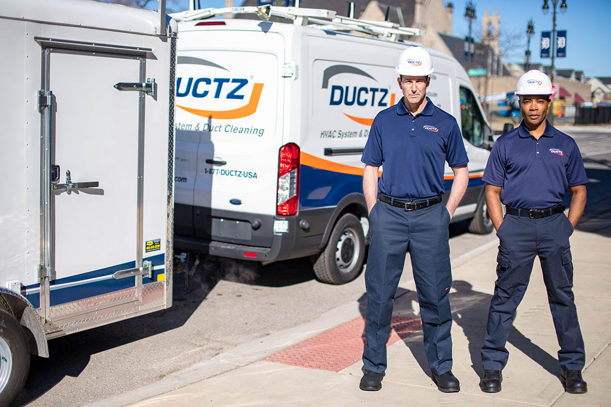 DUCTZ technicians in front of vans buy a franchise