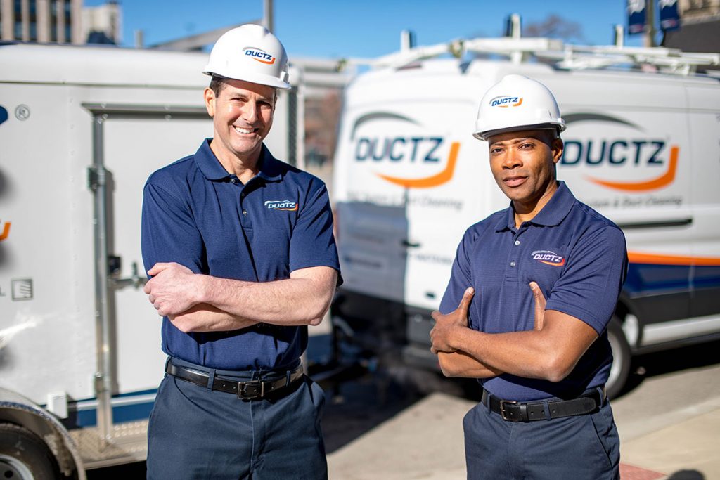 DUCTZ technicians in front of vans