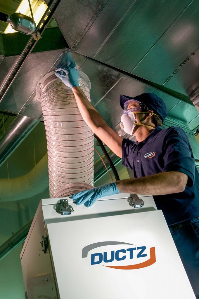 DUCTZ franchise technician cleaning air duct